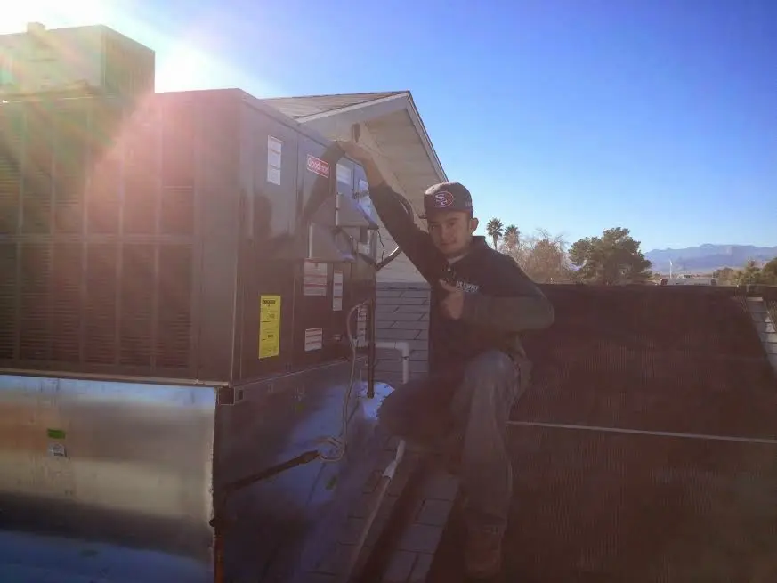 HVAC technician performing HVAC Inspection on a rooftop unit in Havre de Grace